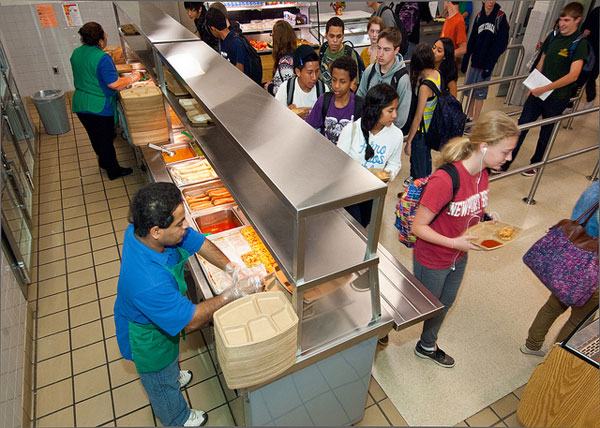 Workers and students in a school cafeteria