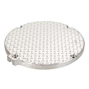 The FTCA-22 Fabricated Top Cover is a round silver metal manhole cover with a diamond-patterned textured surface and two small lifting holes, designed for access to super-capacity grease interceptors in restaurants.